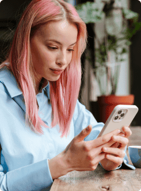 A lady with pink hair on her phone